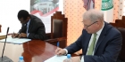 AKU Provost Dr Carl Amrhein (right) signs the MoU with Prof Anthony Mshandete, Deputy Vice Chancellor at NM-AIST